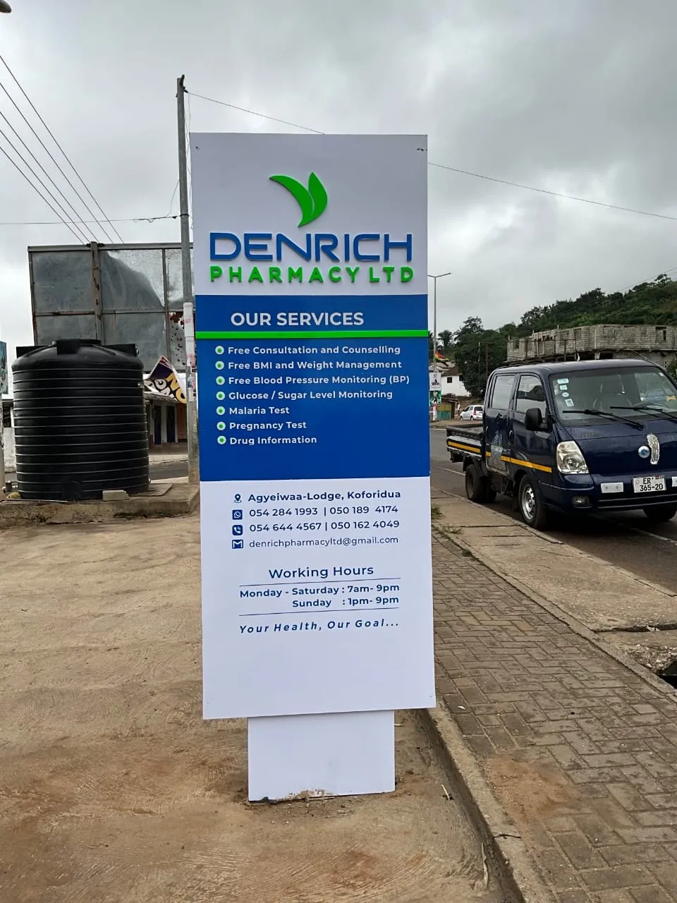 DenRich Pharmacy signboard listing services, phone numbers and opening hours